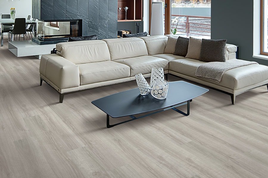 Spacious living room with grey waterproof flooring and cream sectional sofa