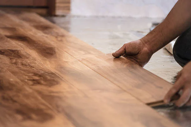 Flooring professional installing hardwood flooring