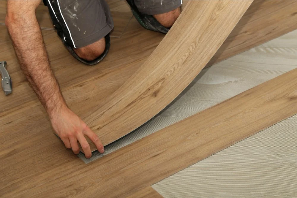 Flooring professional installing luxury vinyl floors