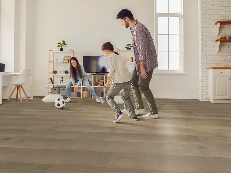 Family playing with ball in open concept room