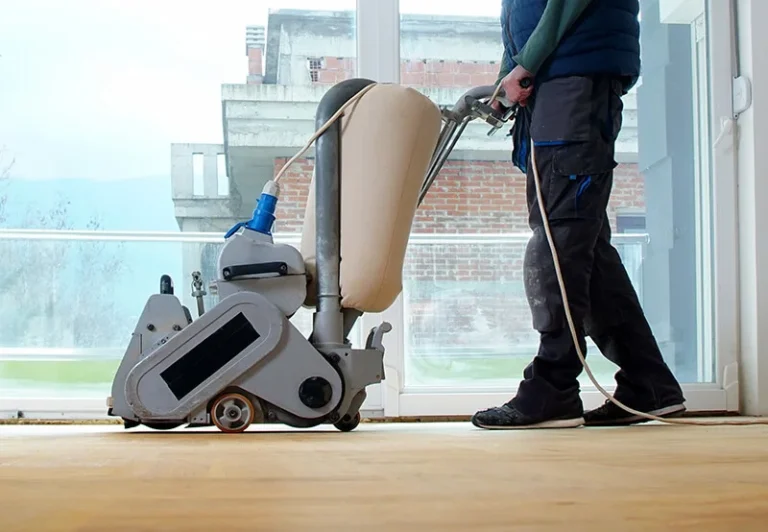Person sanding hardwood flooring